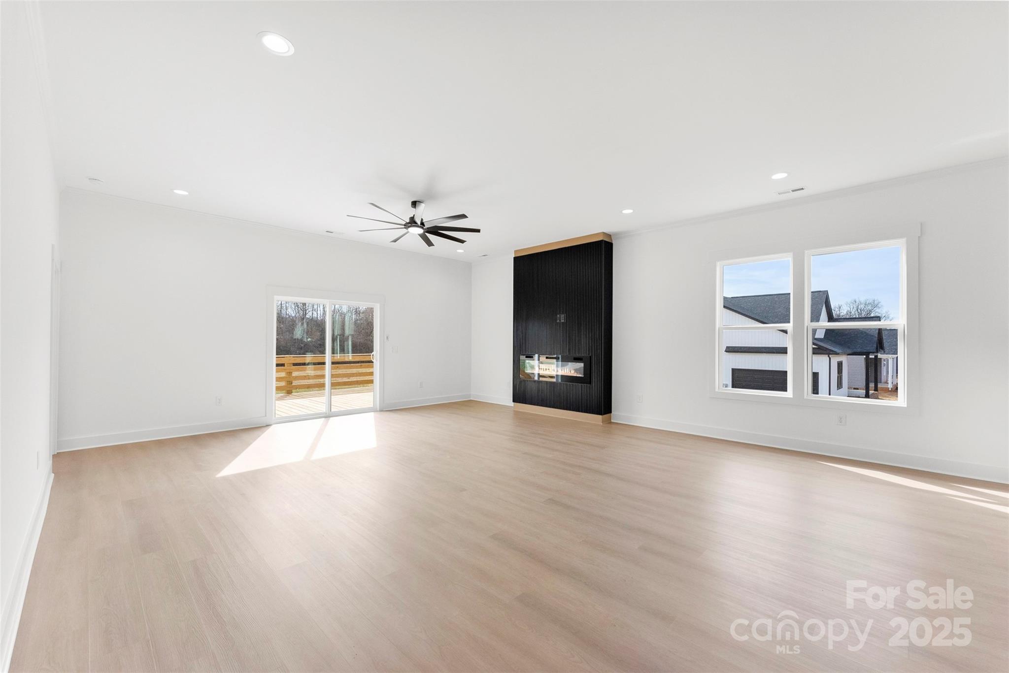 4085 Miller Road Salisbury, NC 28147 - Photo 15 of 46 a view of a livingroom with wooden floor and a ceiling fan
