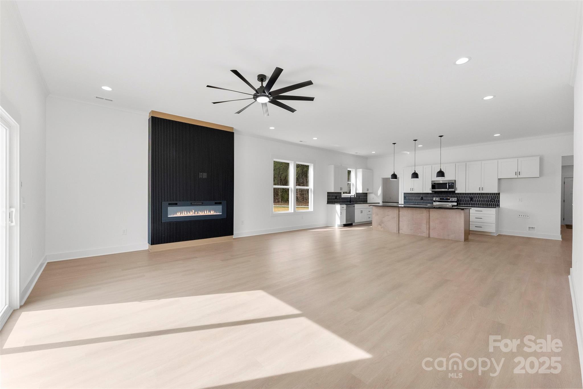 4085 Miller Road Salisbury, NC 28147 - Photo 17 of 46 a living room with stainless steel appliances kitchen island furniture and a kitchen view