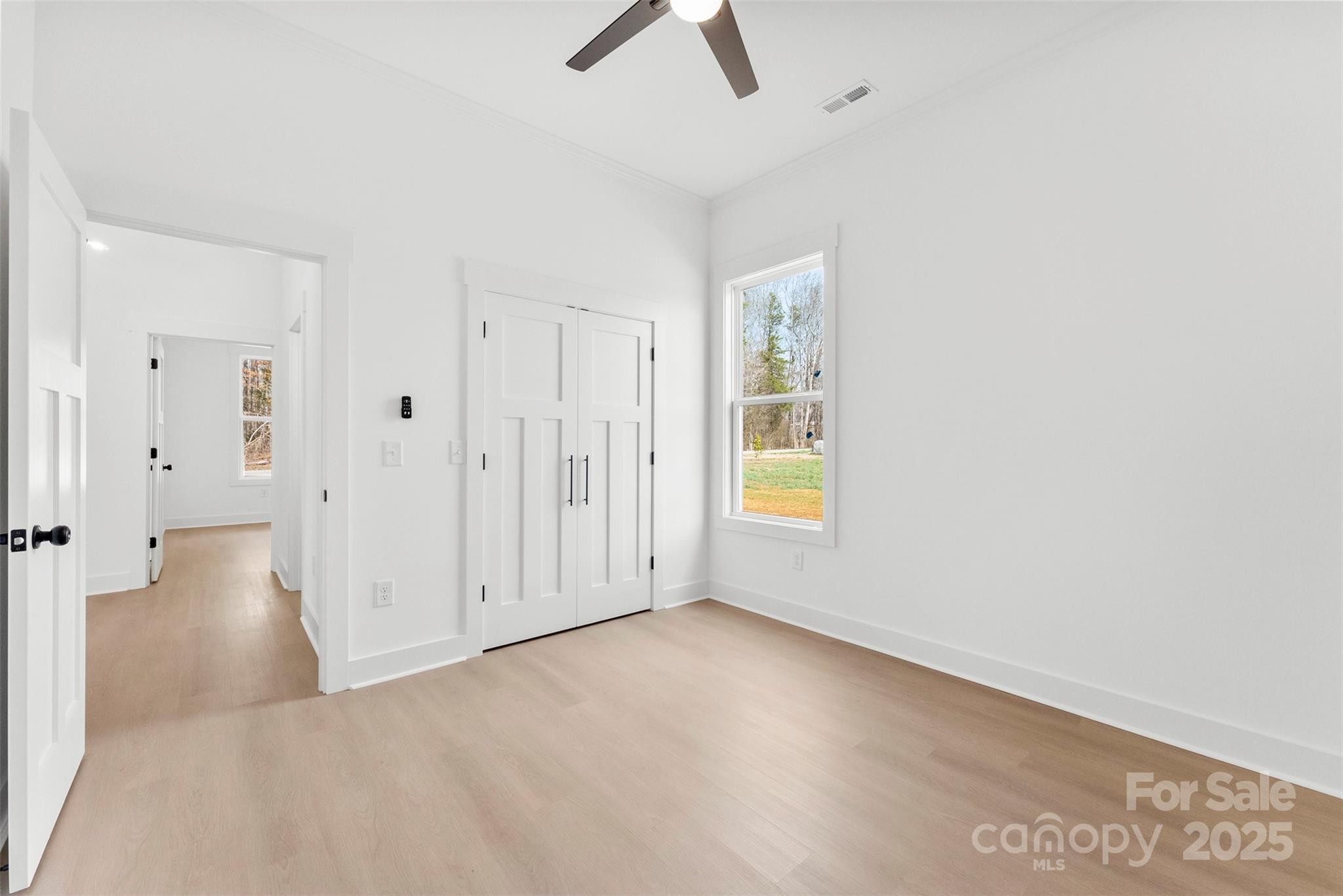 4085 Miller Road Salisbury, NC 28147 - Photo 35 of 46 an empty room with chandelier fan and windows