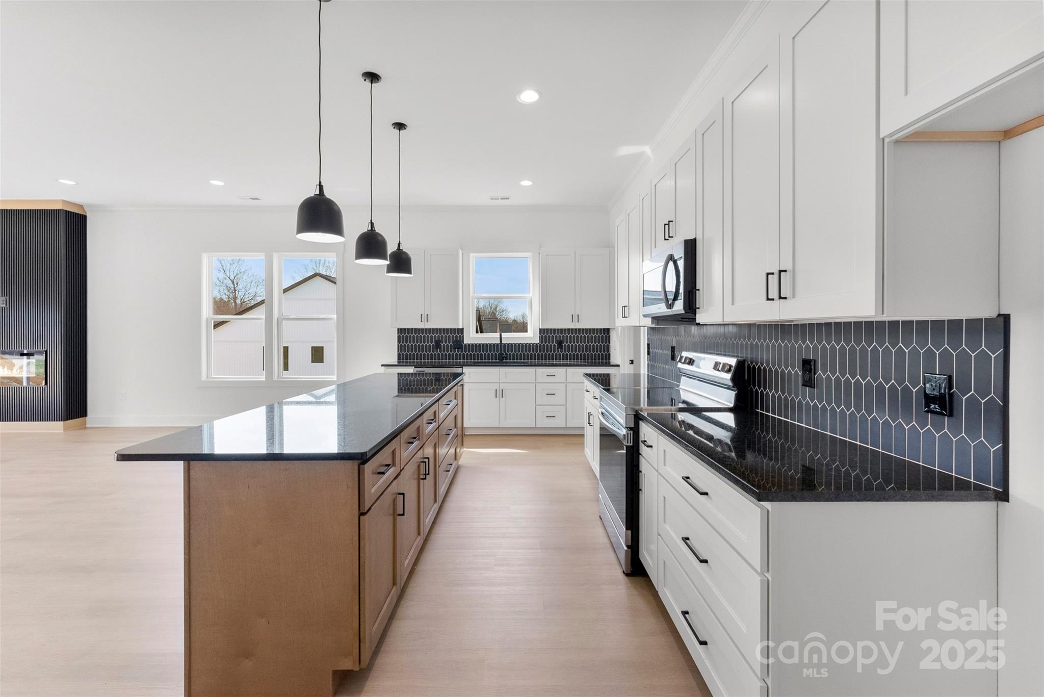 4085 Miller Road Salisbury, NC 28147 - Photo 7 of 46 a kitchen with kitchen island granite countertop a sink a counter top space and stainless steel appliances