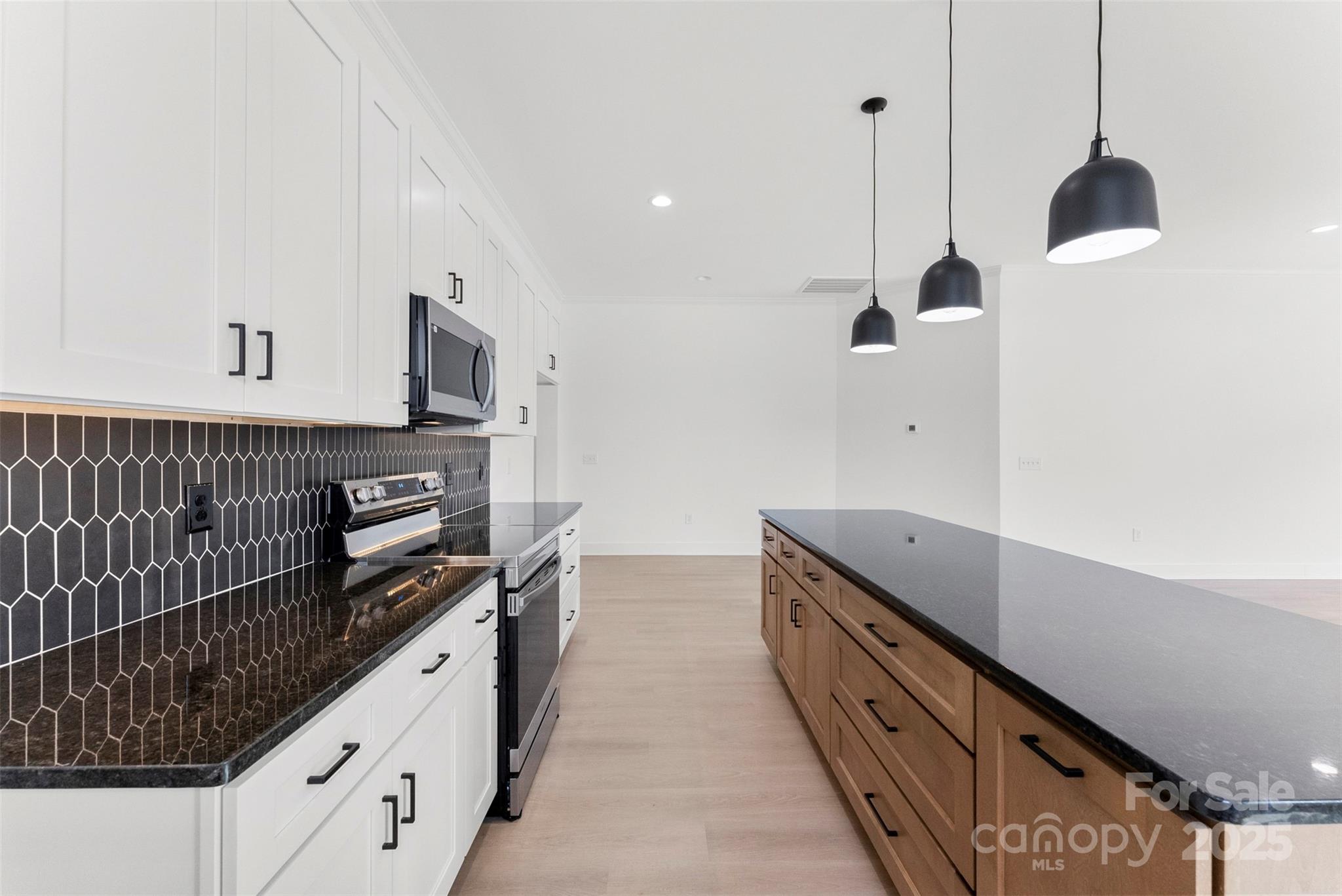4085 Miller Road Salisbury, NC 28147 - Photo 9 of 46 a kitchen with stainless steel appliances a sink and a wooden floor