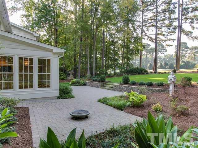 7003 North Ridge Drive Raleigh, NC 27615 - Photo 2 of 25 a front view of a house with a yard and shrubs