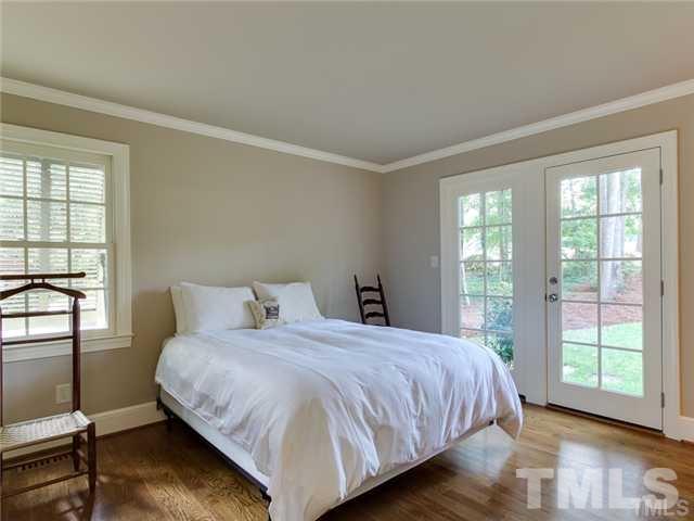 7003 North Ridge Drive Raleigh, NC 27615 - Photo 11 of 25 a bedroom with a bed and wooden floor