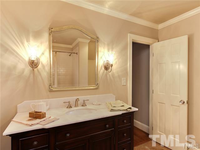 7003 North Ridge Drive Raleigh, NC 27615 - Photo 12 of 25 a bathroom with a granite countertop sink and a mirror