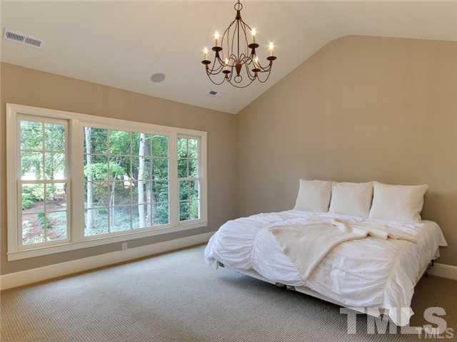 7003 North Ridge Drive Raleigh, NC 27615 - Photo 16 of 25 a bedroom with a bed and a window