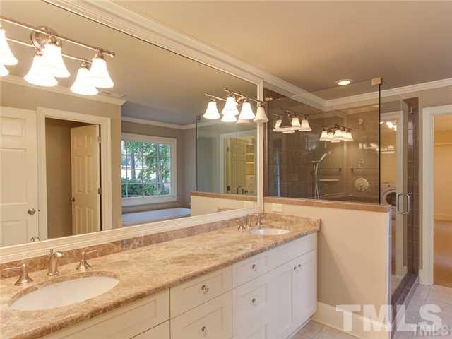 7003 North Ridge Drive Raleigh, NC 27615 - Photo 18 of 25 a bathroom with a granite countertop sink mirror and a shower