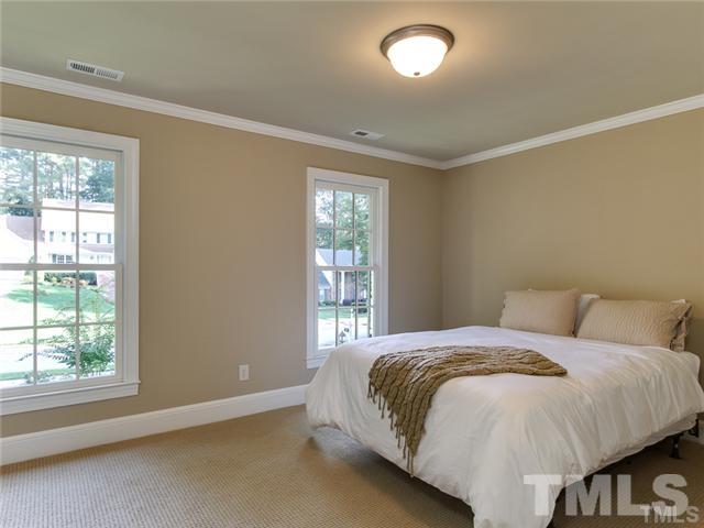 7003 North Ridge Drive Raleigh, NC 27615 - Photo 20 of 25 a bedroom with a bed and window