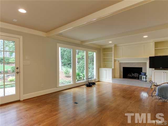 7003 North Ridge Drive Raleigh, NC 27615 - Photo 3 of 25 a view of an empty room with a fireplace and a window