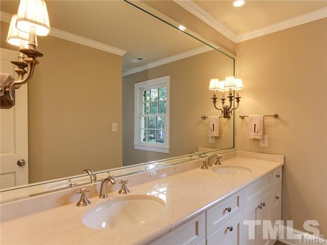 7003 North Ridge Drive Raleigh, NC 27615 - Photo 22 of 25 a bathroom with a sink and a mirror
