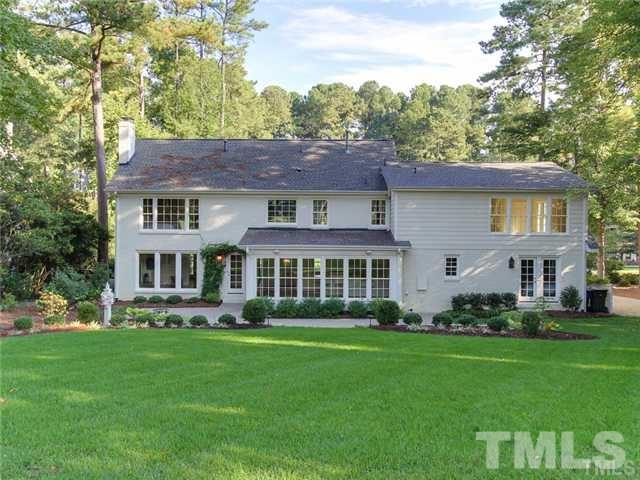 7003 North Ridge Drive Raleigh, NC 27615 - Photo 24 of 25 a front view of a house with a yard table and chairs