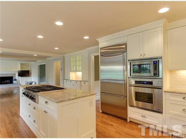 7003 North Ridge Drive Raleigh, NC 27615 - Photo 4 of 25 a kitchen with stainless steel appliances granite countertop a stove and a refrigerator