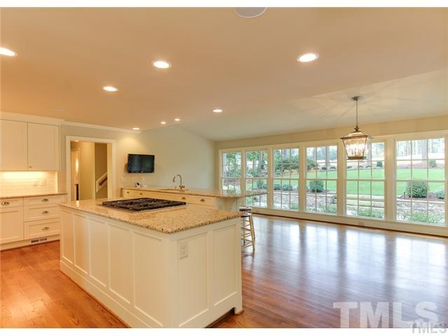 7003 North Ridge Drive Raleigh, NC 27615 - Photo 5 of 25 a open kitchen with stainless steel appliances granite countertop a stove top oven a sink and a refrigerator