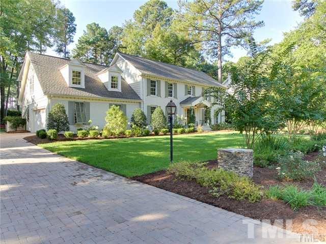 7003 North Ridge Drive Raleigh, NC 27615 - Photo 6 of 25 a view of house in front of a big yard with large trees