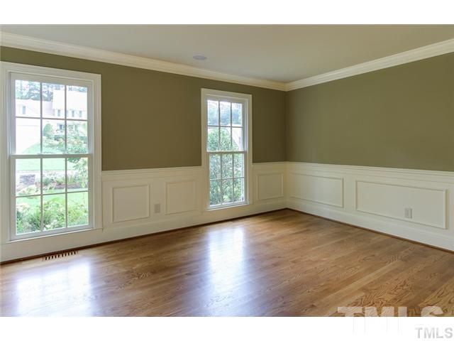 7003 North Ridge Drive Raleigh, NC 27615 - Photo 9 of 25 an empty room with wooden floor and windows