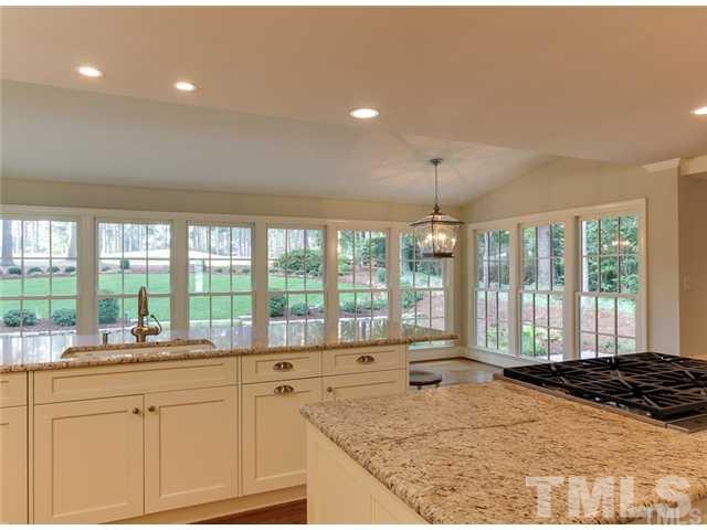 7003 North Ridge Drive Raleigh, NC 27615 - Photo 10 of 25 a large kitchen with granite countertop a sink and a large window