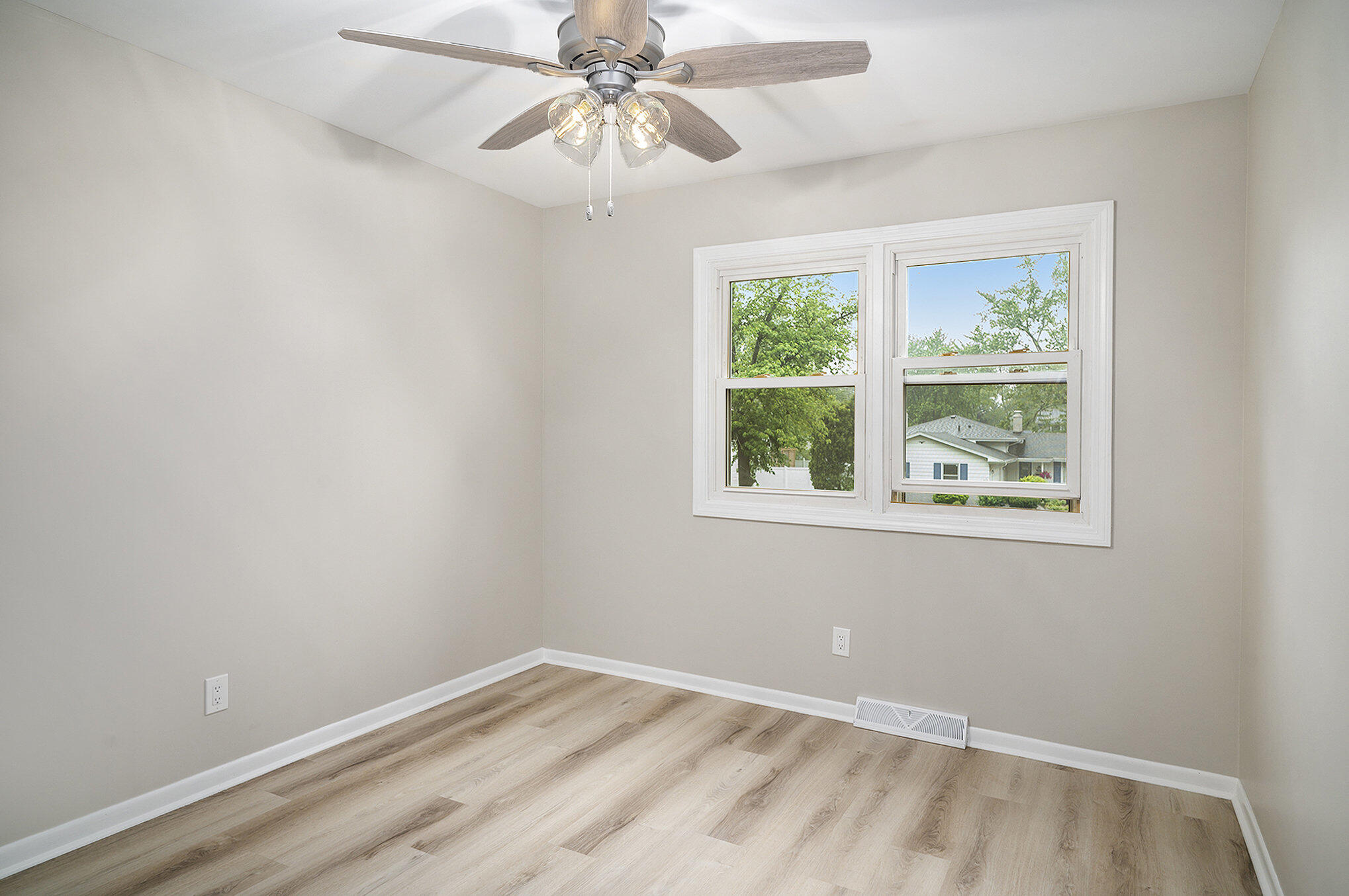 9307 Walnut Drive Munster, IN 46321 - Photo 14 of 26 an empty room with a window and a fan
