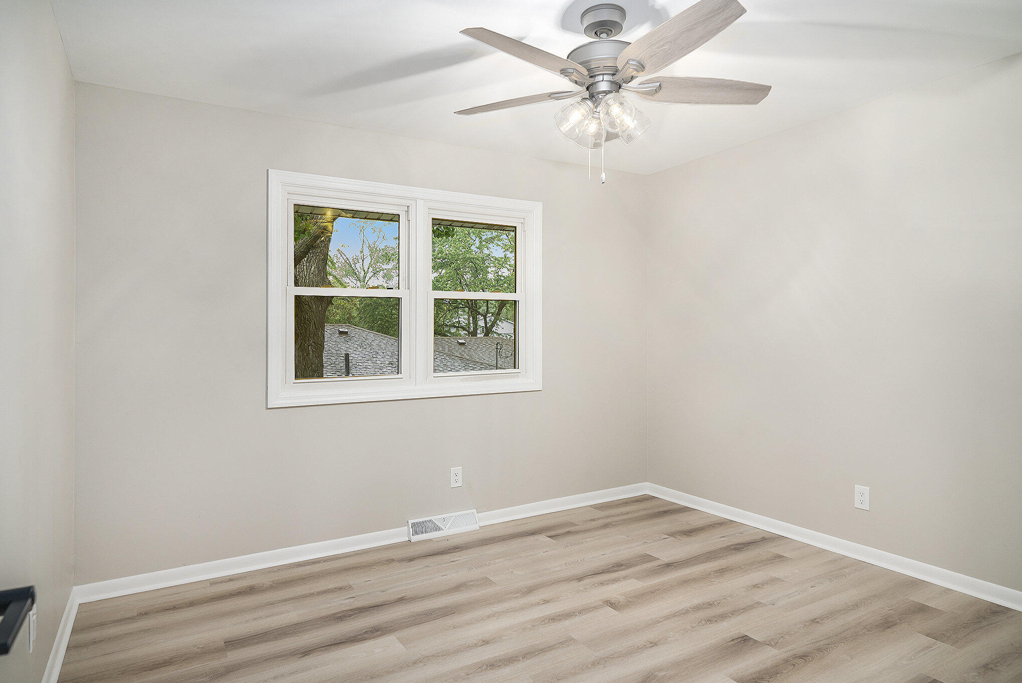 9307 Walnut Drive Munster, IN 46321 - Photo 16 of 26 an empty room with a window and a ceiling fan