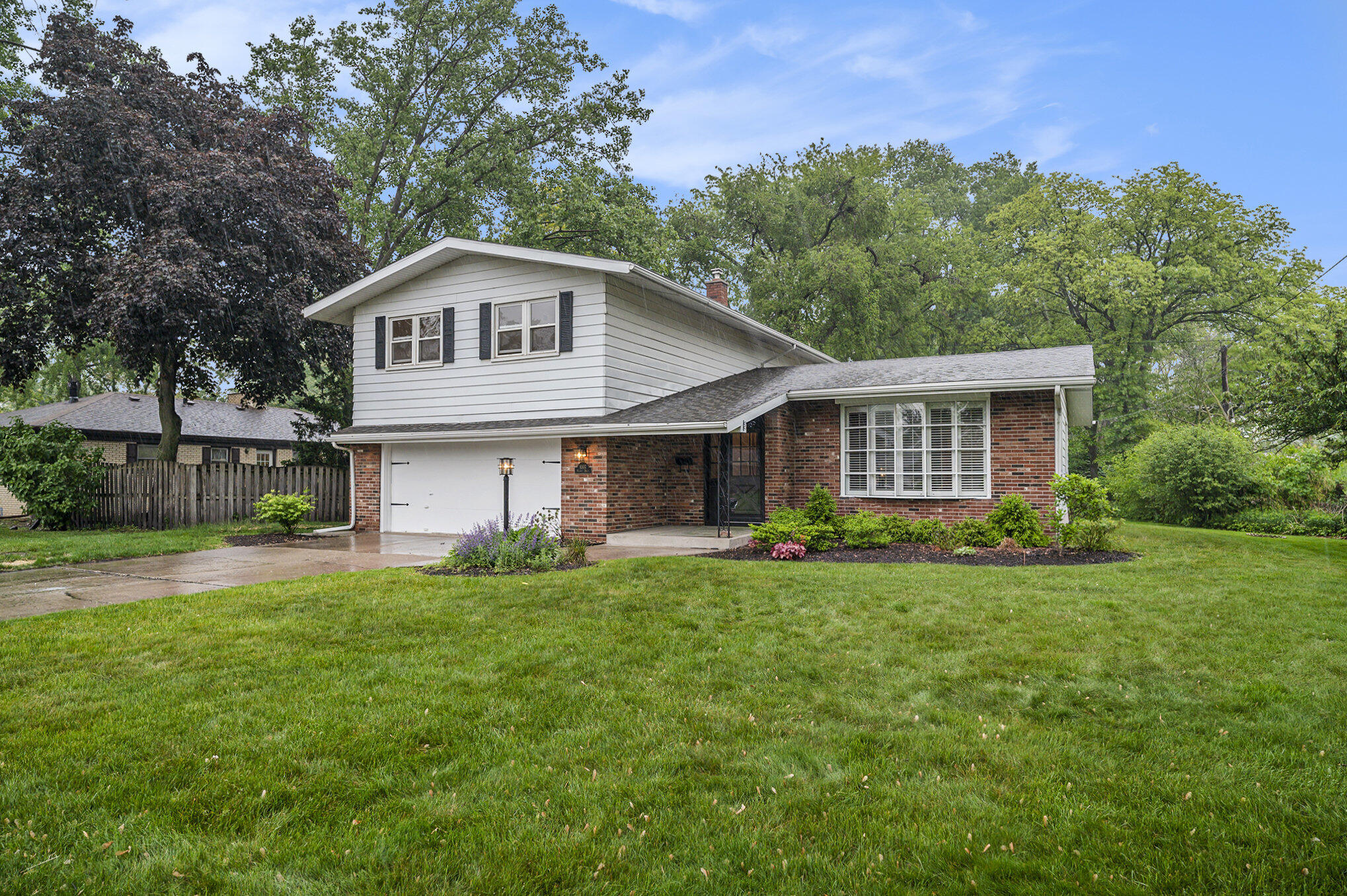 9307 Walnut Drive Munster, IN 46321 - Photo 24 of 26 a front view of a house with a yard and trees
