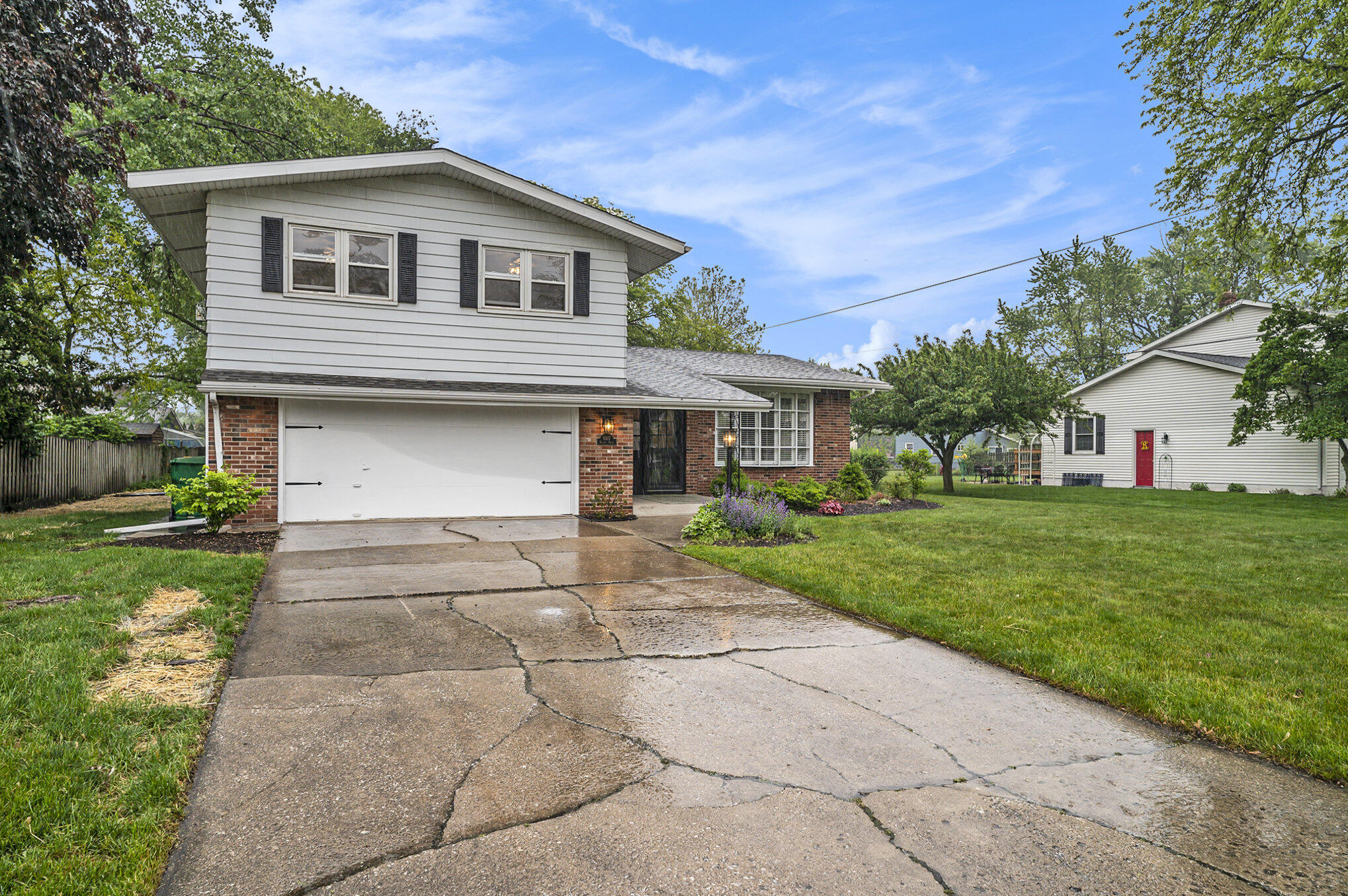 9307 Walnut Drive Munster, IN 46321 - Photo 25 of 26 a front view of a house with a yard and garage