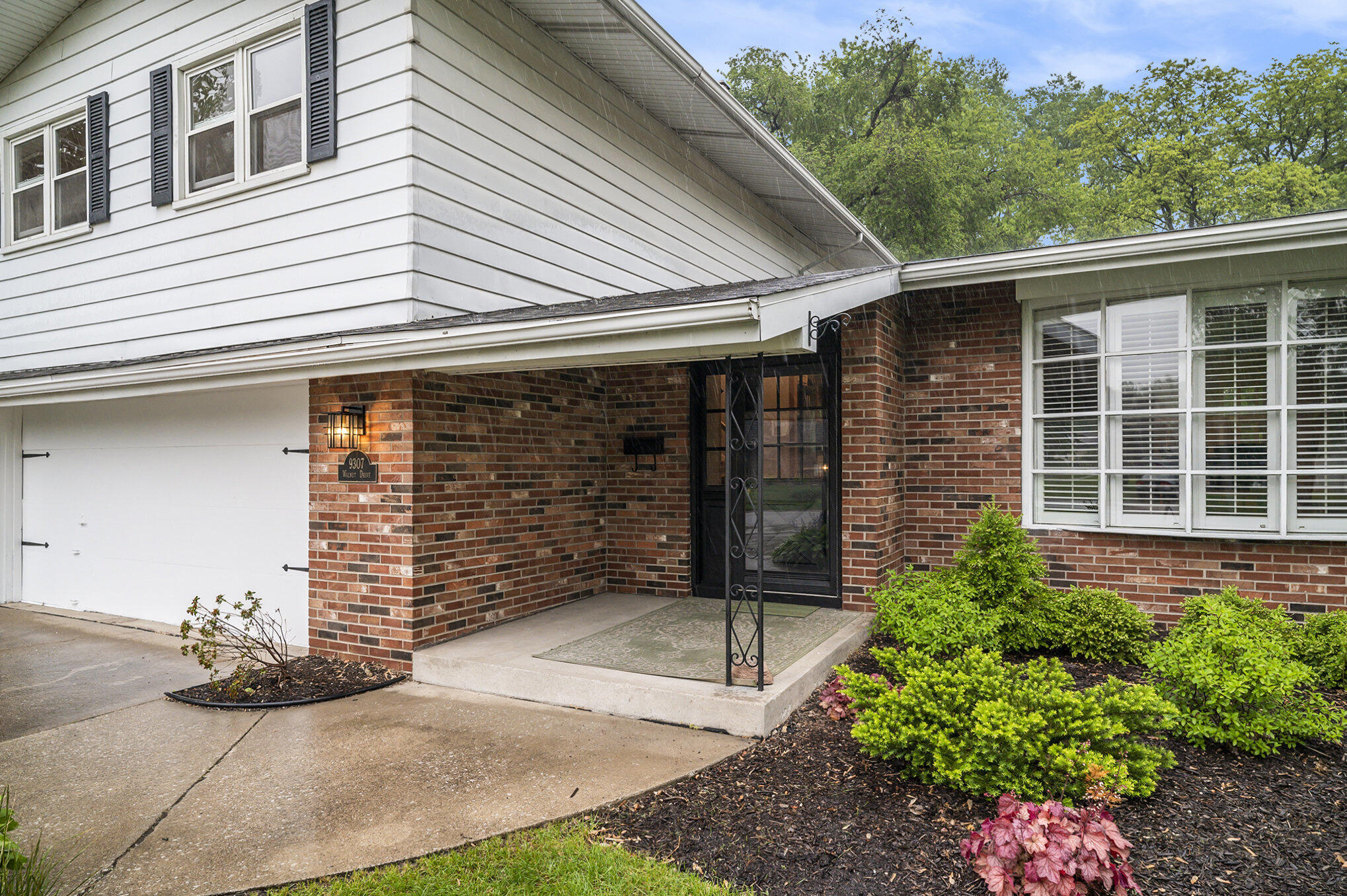 9307 Walnut Drive Munster, IN 46321 - Photo 26 of 26 a front view of a house with a garden