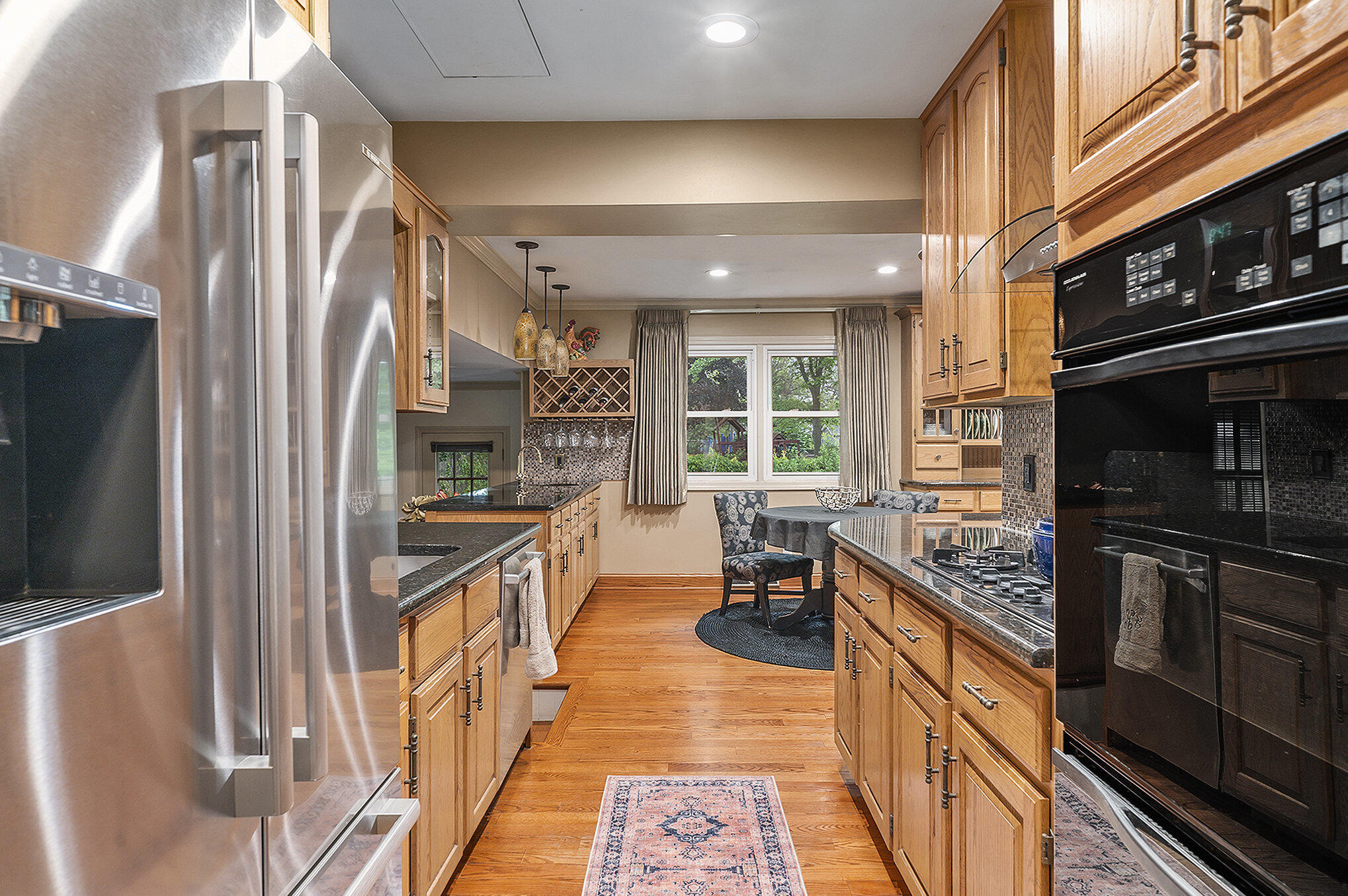 9307 Walnut Drive Munster, IN 46321 - Photo 7 of 26 a kitchen with stainless steel appliances granite countertop a refrigerator a stove and a sink