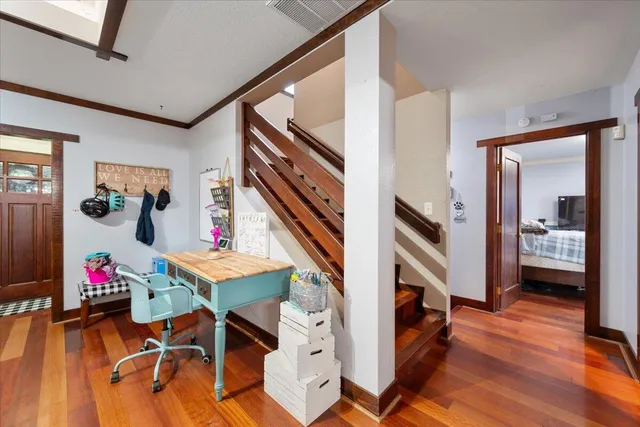 a living room with furniture and wooden floor