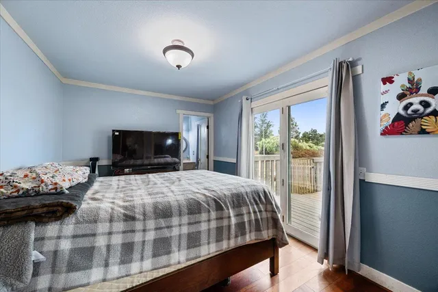 a bedroom with a bed and a tv