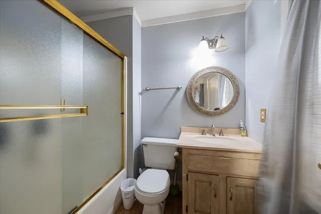 a bathroom with a sink toilet and a mirror