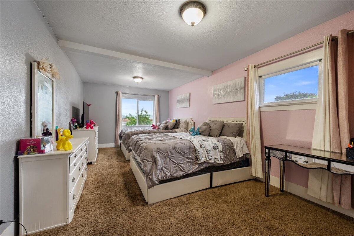 524 Avalon Street Lompoc, CA 93436 - Photo 23 of 36 a spacious bedroom with a bed and a dresser