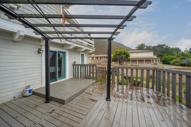 a view of a balcony with wooden floor