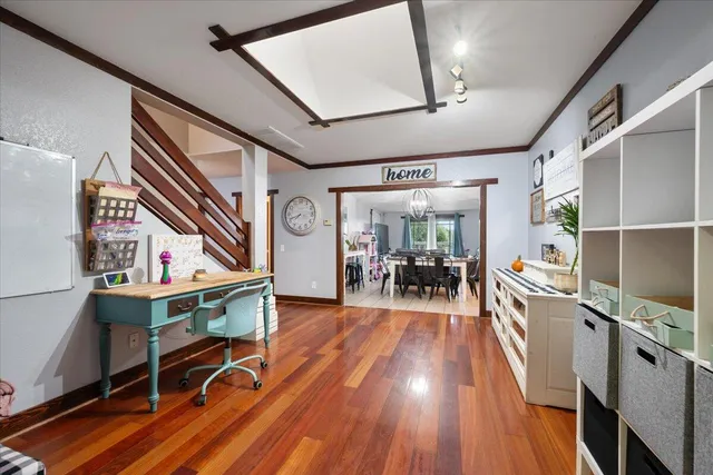 a view of a room with wooden floor and furniture