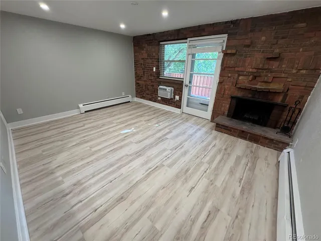 wooden floor in an empty room with a fireplace
