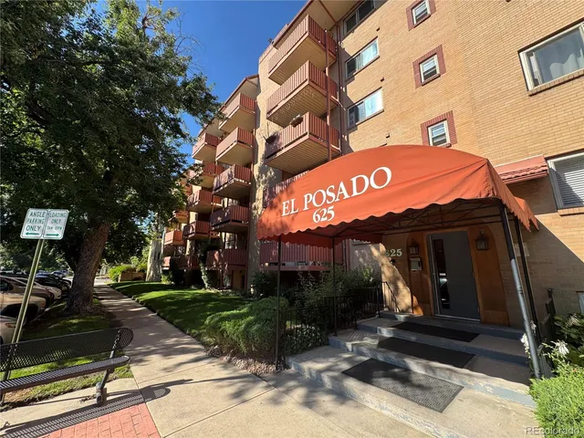 a view of a building with a tree in front of it