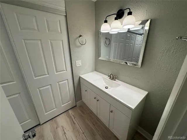 a bathroom with a sink vanity and mirror