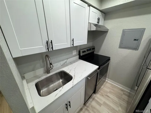 a kitchen with a sink and a refrigerator