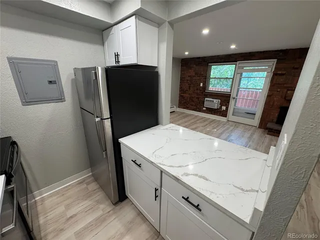 a kitchen with a refrigerator and a sink