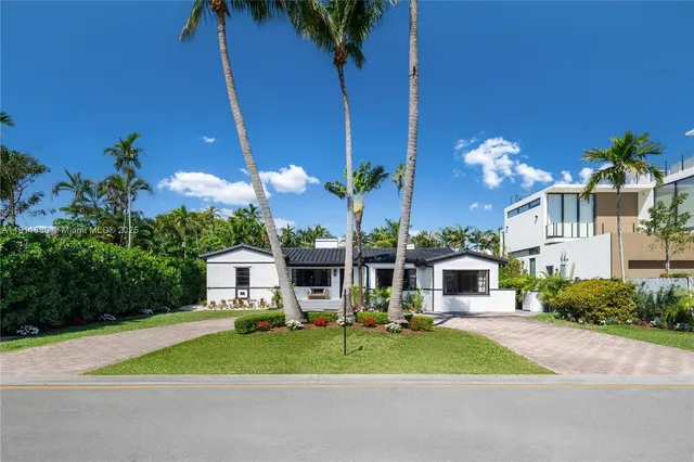 a view of a house with a yard and garage