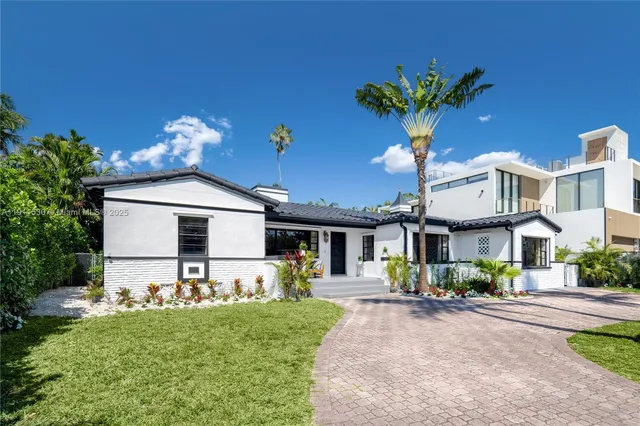 a front view of a house with a yard and staircase