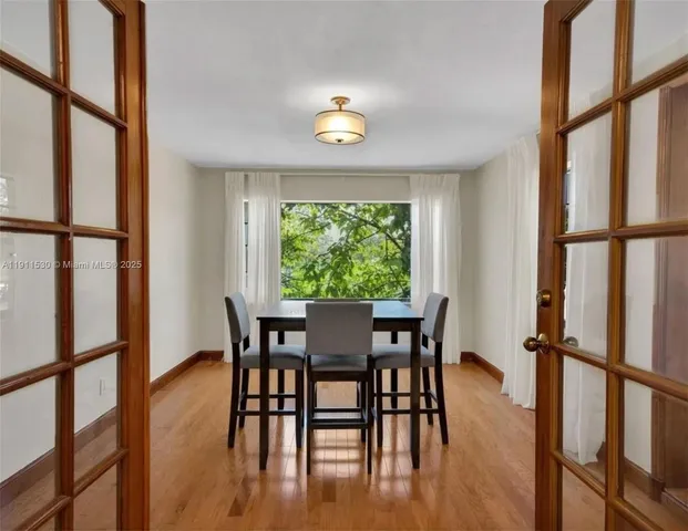a view of a dining room with furniture window and wooden floor