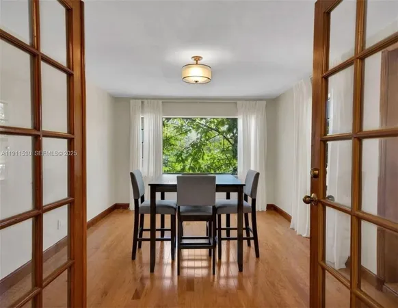a view of a dining room with furniture window and wooden floor