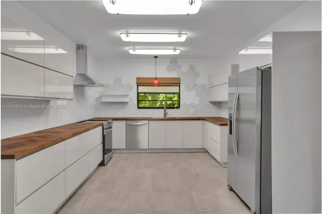 a view of a kitchen with a cabinets and chandelier