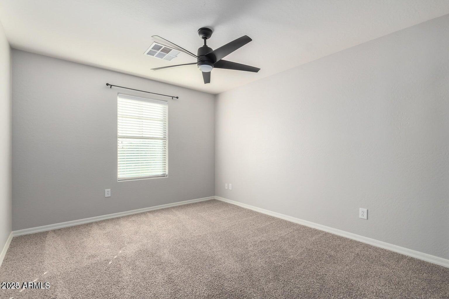4674 South Twinleaf Drive Gilbert, AZ 85297 - Photo 11 of 18 an empty room with a window and a fan
