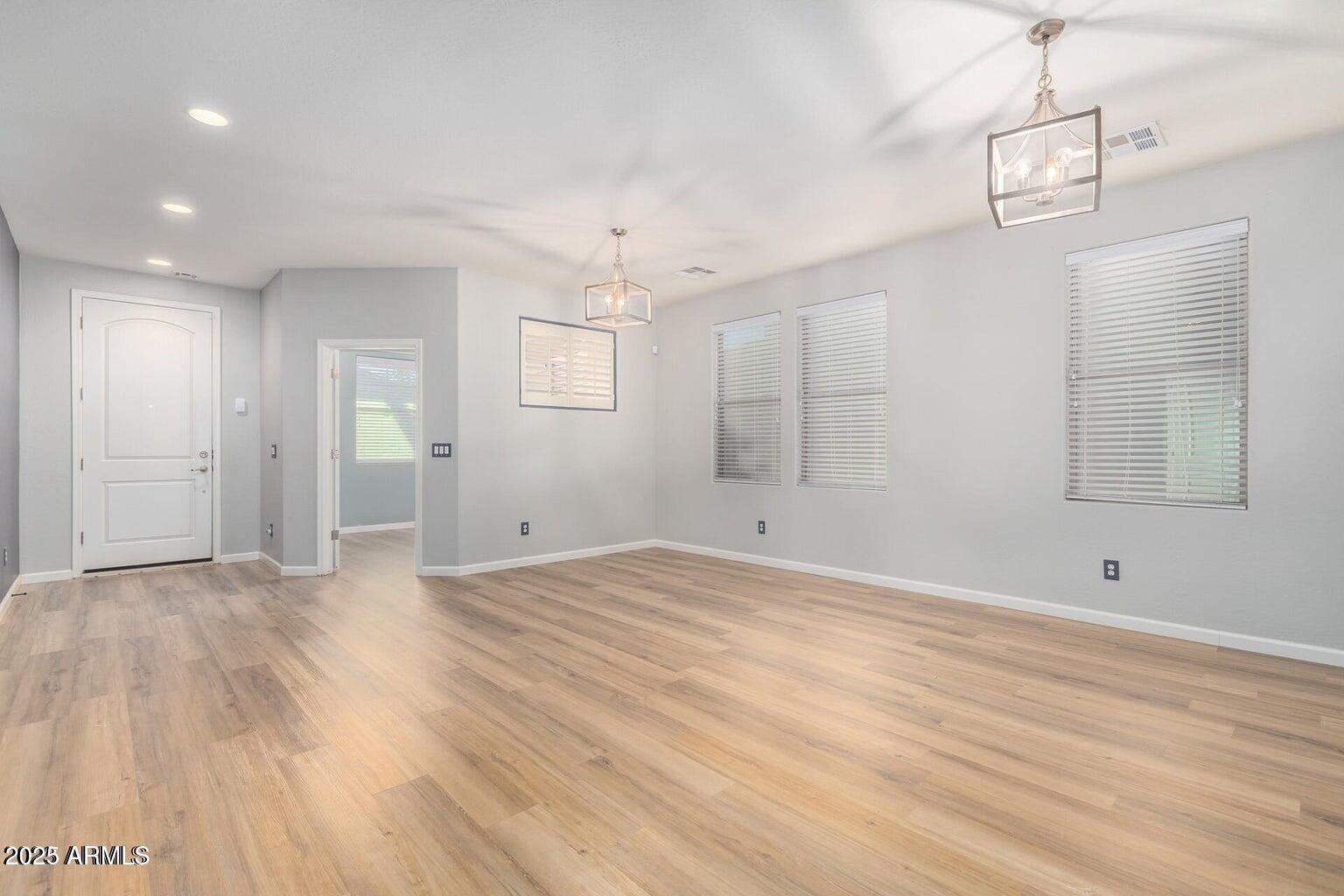 4674 South Twinleaf Drive Gilbert, AZ 85297 - Photo 3 of 18 a view of empty room with wooden floor and ceiling fan