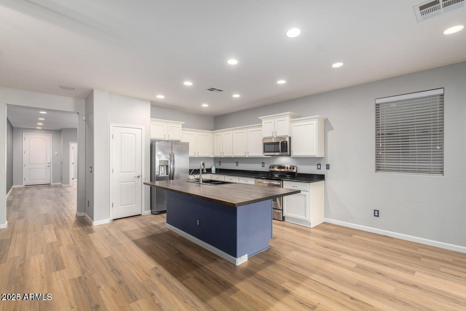 4674 South Twinleaf Drive Gilbert, AZ 85297 - Photo 6 of 18 a kitchen with stainless steel appliances granite countertop a stove and a sink