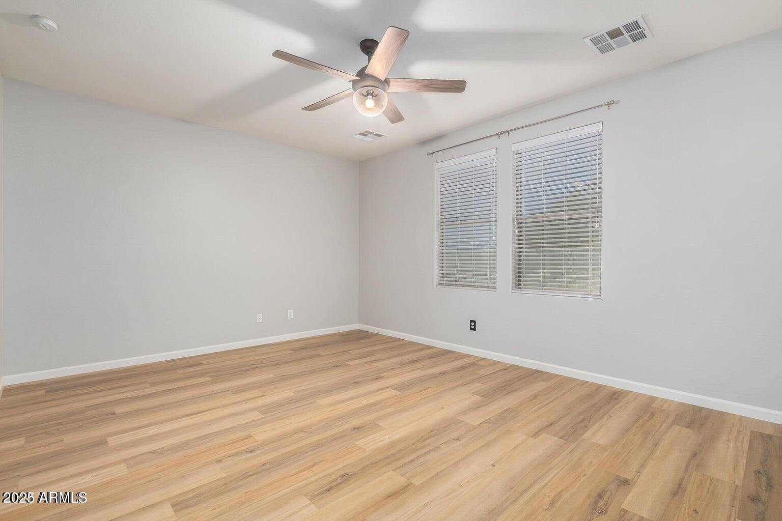 4674 South Twinleaf Drive Gilbert, AZ 85297 - Photo 8 of 18 wooden floor in an empty room with a window