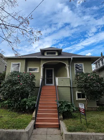 a front view of a house with garden