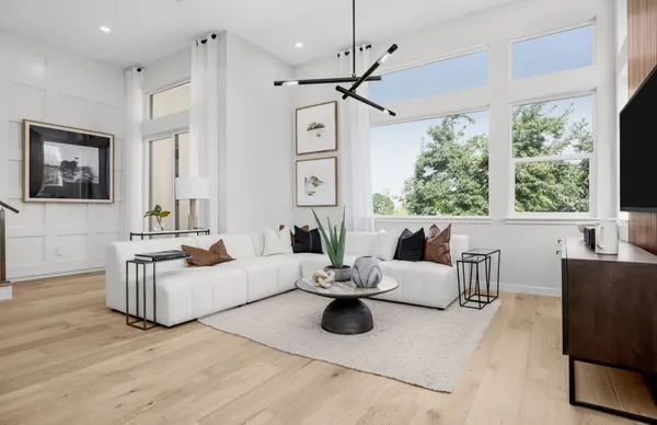 a kitchen with stainless steel appliances a table chairs refrigerator and sink