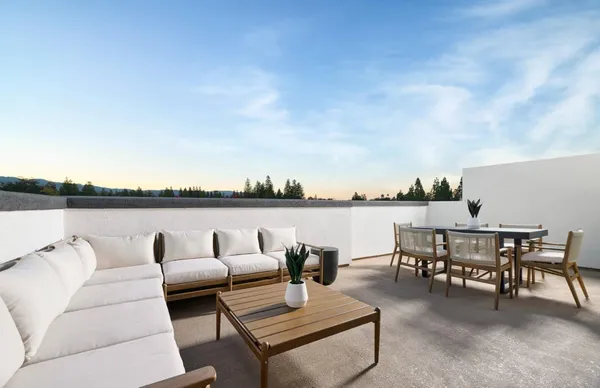 a view of balcony with a table and chairs