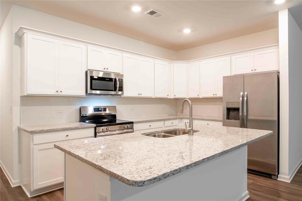 12006 Crosswicks Road, Unit SUNBURST Union City, GA 30291 - Photo 15 of 24 a kitchen with stainless steel appliances granite countertop a sink a stove and a refrigerator