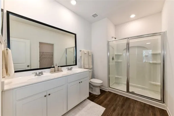 a bathroom with a double vanity sink mirror and toilet